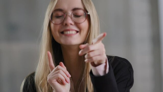 Portrait Of Energetic Motivated Businesswoman Caucasian Blonde Lady In Glasses Happy Girl Manager Worker Dances Having Fun Active Moving Movements With Index Fingers To Music Joy Victory Winning Offer