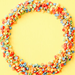 A multicolored circle on a yellow background.