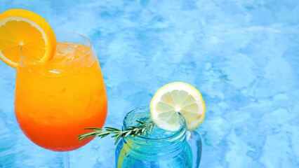 Close up view of two glasses of exotic non-alcohol ice fruit cocktails near pool in luxury resort hotel. Concept of travel, vacation, tropical holidays