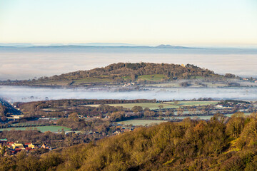 Fototapeta na wymiar A temperature inversion causing fog to obscure the Vale of Gloucester, England UK. Churchdown Hill (Chosen Hill) is standing clear.