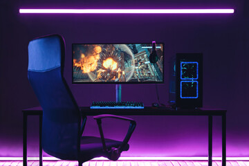 General view of home workplace of pro gamer with professional gaming setup on desktop. Modern...