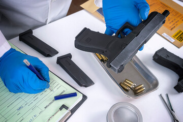 police scientist examines firearm involved in murder at crime lab, concept image