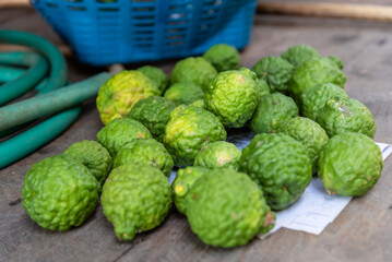 Kaffir limes, bergamot, ingredient for healthy thai food and beauty products on wood table.