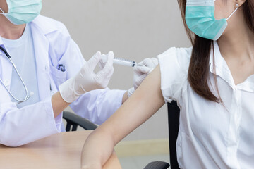 Doctor Holding Syringe Injecting the Vaccine into Patient Shoulder