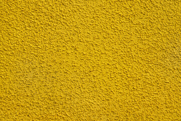 Fototapeta premium Textured background with yellow wall pattern.Rough plaster on a concrete wall.Bright yellow background.Texture.