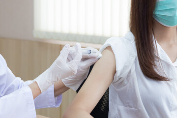 Doctor Holding Syringe Injecting the Vaccine into Patient Shoulder