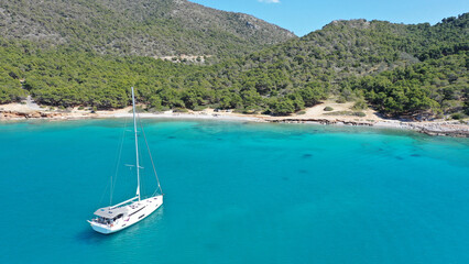 Aerial drone photo of paradise bay and turquoise beach of Dragonera covered in pine trees in small island of Agistri, Greece