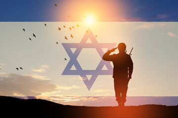 Silhouette of soliders saluting against the sunrise in the desert and Israel flag. Concept - armed...
