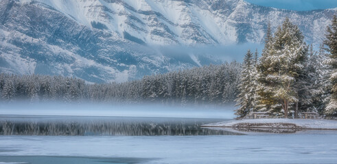 Mesmerizing view of frozen lake and snow-capped mountains in Banff, Alberta, Canada