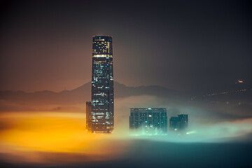 Abstract futuristic wallpaper with orange and blue mist spreading around tall buildings at night