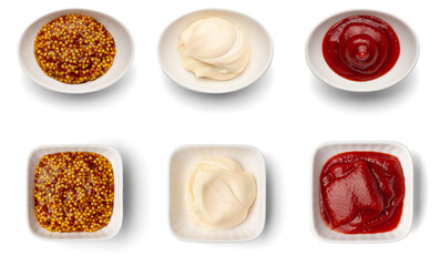 Mustard, mayonnaise, ketchup in a ceramic gravy boat. Top view of three sauces isolated on white background.