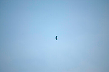 Fototapeta na wymiar Paragliding in the Blue Sky