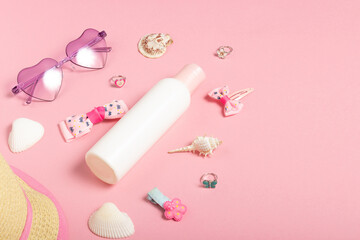 Baby accessories sunglasses and a hat on a pink background. Little girls accessories, flat lay