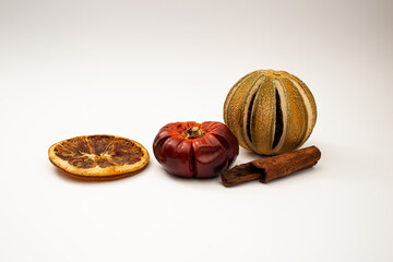 Dried fruit, fruit and cinnamon on white background