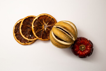 Dried fruit, fruit and cinnamon on white background