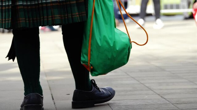  St Patrick's day street celebration with man in kilt tapping feet to music