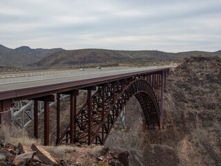 An arched bridge spanning a rugged canyon in Arizona