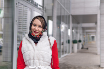 happy young woman in headscarf in cold weather outdoors