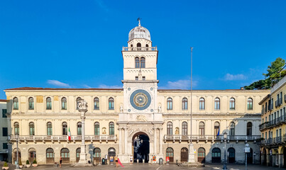 Fototapeta na wymiar Scenic view on the astronomical clock from empty Piazza dei Signori in Padua, Veneto, Italy, Europe. Column of winged lion statue of Saint Mark background Astronomical Clock. Central square in Padova
