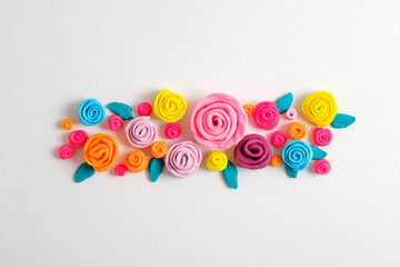 plasticine flower composition on white background, plasticine background, flower arrangement of roses