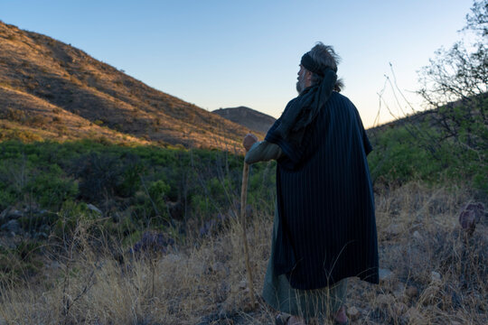 A Bible prophet or holy man standing in the desert wilderness
