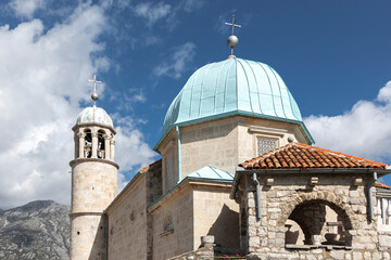 Fototapeta na wymiar The blue domes of a church in the sea Montenegro