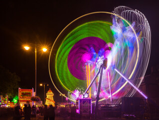 Fairground ride light traces from 'Storm' and 'The King' at st Giles fair, Oxford, the UK