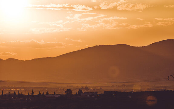 Dramatic silhouette of Zaghouan mountains at orange sunset, Tunisia