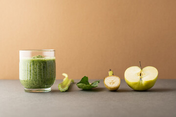 Composition with a glass of delicious detox juice (smoothie) and ingredients on colour background