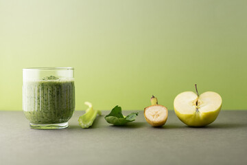 Composition with a glass of delicious detox juice (smoothie) and ingredients on colour background