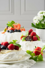 mini pavlova meringues with whipped cream and berries
