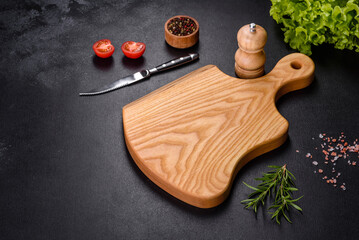 A wooden cutting board with a kitchen knife with spices and herbs