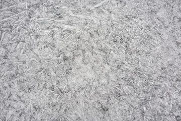 Ice on frozen river forming crystal like structures, closeup macro detail from above - abstract winter background