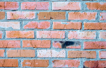 Texture - a wall of old red brick with different shades