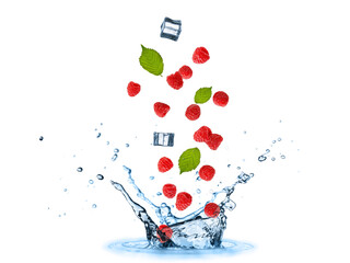 Fresh raspberry berries with leaves and ice cubes flying falling in splashing water isolated on...