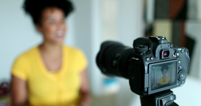 Mixed race woman giving testimony in front of camera vlogging