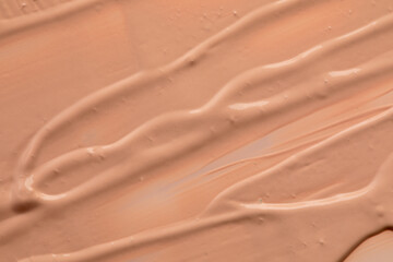 Beige nude liquid foundation texture, concealer smear smudge drop. Closeup macro. Cosmetic tonal makeup moisturizer, bb cream swatch sample.- Image