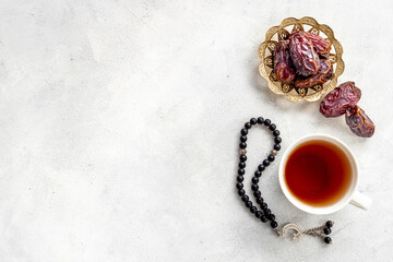 Islamic rosary with dates and tea. Ramadan Kareem concept.