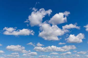 Naklejka na ściany i meble white fluffy clouds in a blue sky