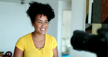 Millennial female vlogger talking at camera