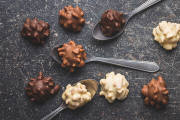 Chocolate truffles. Sweet pralines on black table.