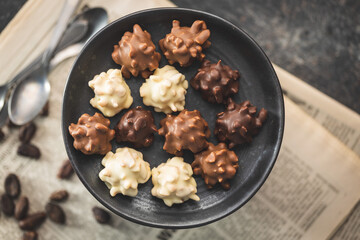 Chocolate truffles. Sweet pralines on plate.