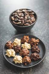 Chocolate truffles. Sweet pralines on plate.