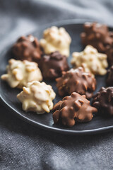 Chocolate truffles. Sweet pralines on plate.