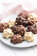 Chocolate truffles. Sweet pralines on plate.