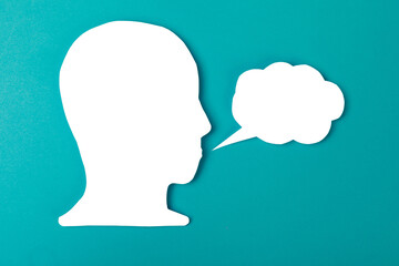  paper face and speech bubble on colorbackground copy space for text, communication, symbolic- Image