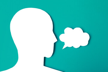  paper face and speech bubble on colorbackground copy space for text, communication, symbolic- Image