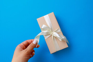  Womans hand holding Gift box on color background. Happy womens day. Happy Mothers day.Hello Spring- Image