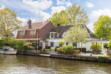 Fototapeta na wymiar Village houses along the river Vecht near the village of Vreeland in the Netherlands.