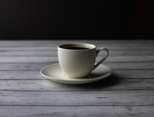 A cup of coffee, tea on a wooden table on black background